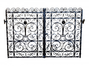A pair of small early 20th century decorative wrought iron garden gates
