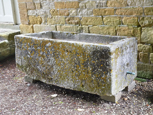 A large rectangular stone trough