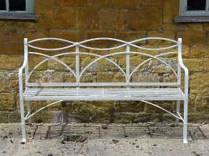 A wrought iron Regency garden seat 