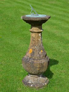 An early 20th century carved natural Horton stone sundial of octagonal form with bronze sundial plate