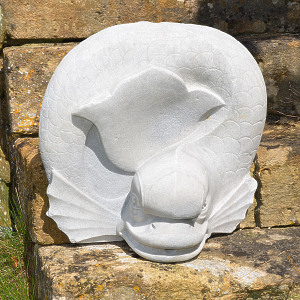 A marble fountain spout in the form of a stylised dolphin