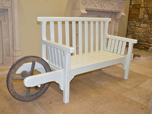A painted wooden 'wheelbarrow seat'