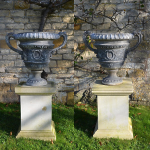 A pair of lead urns of campana form 