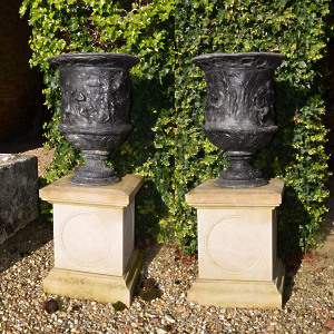 A pair of early 20th century lead urns of Campana form