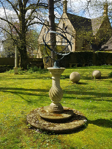 A weathered hand carved natural limestone sundial of baluster form