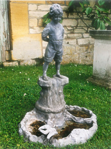 A charming early 20th Century Lead Bird Bath comprising of the figure of a young boy standing upon a tree stump looking over a rocky pool