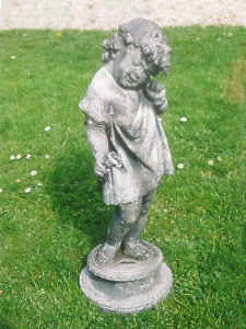 A Sweet early 20th Century lead figure of a girl holding a flower