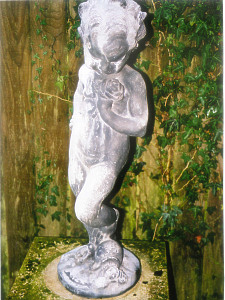 An early 20th Century, Circa 1910, lead standing figure of a young girl holding a rose
