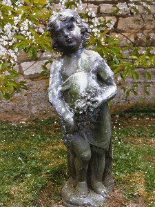 A pretty 19th Century lead statue of a girl with flowers