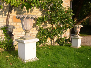 A pair of Austin and Seeley composition stone urns