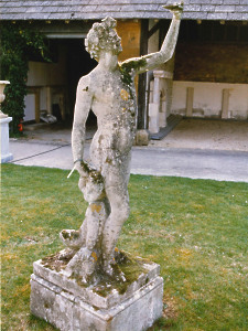 A 19th Century composition stone statue depicting Bacchus, the God of Wine