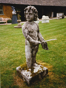 A weathered 19th Century composition stone statue depicting Autumn