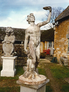 A 19th Century weathered composition statue depicting Bacchus, the God of Wine.
