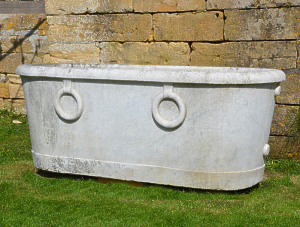 A carved white marble cistern of elongated oval form