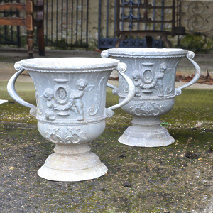 A pair of early 20th century lead urns of campana form
