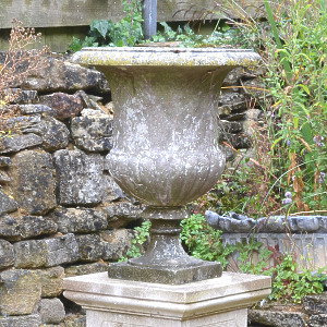 An Italian weathered white marble campana urn