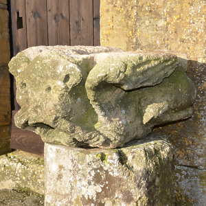 A large medieval carved limestone long fingered mouth puller gargoyle
