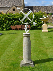 A 20th century Bath stone sundial base surmounted by a Swedish Armillary with sea horse support designed by Sune Rooth