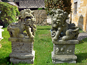 A pair of late 19th century Japanese carved granite Dogs of Foo