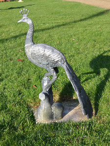 A mid 20th century cast zinc peacock