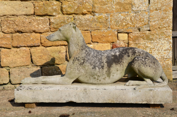 A large pair of composition stone reclining greyhounds by Austin and Seeley