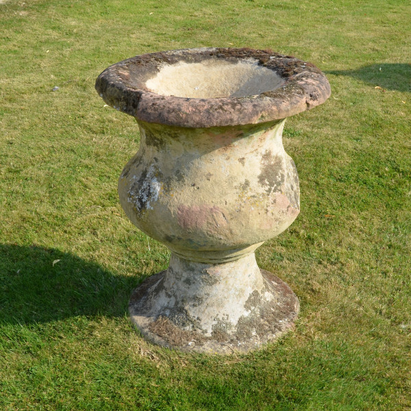 A large-scale single sand stone urn of bulbous form 