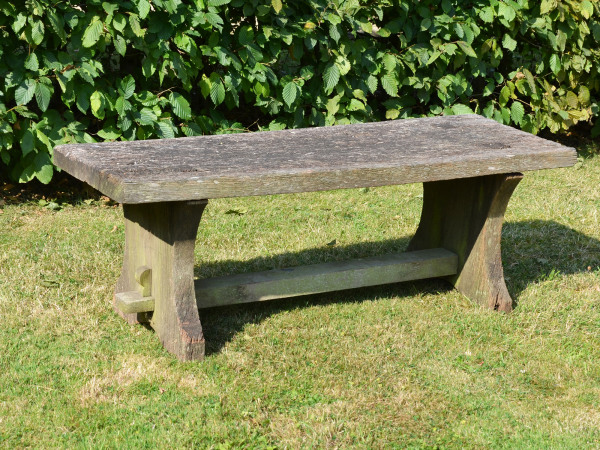 A rustic oak plank bench