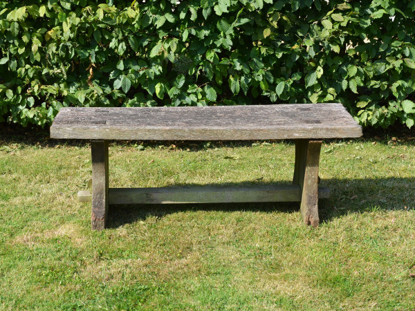 A rustic oak plank bench