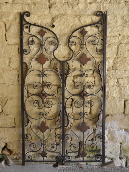 A pair of decorative American mid 20th century wrought and cast iron gates 