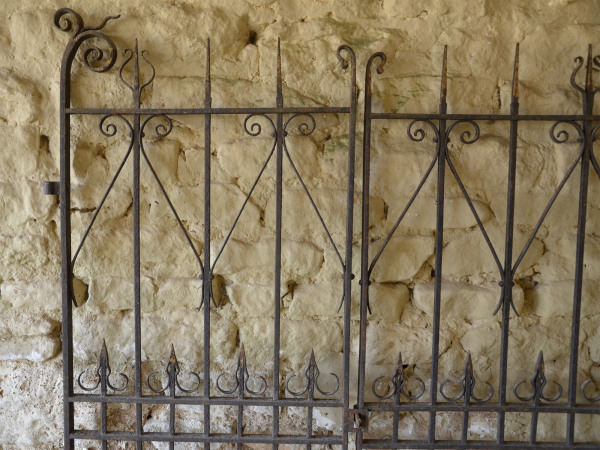A pair of decorative wrought iron gates.