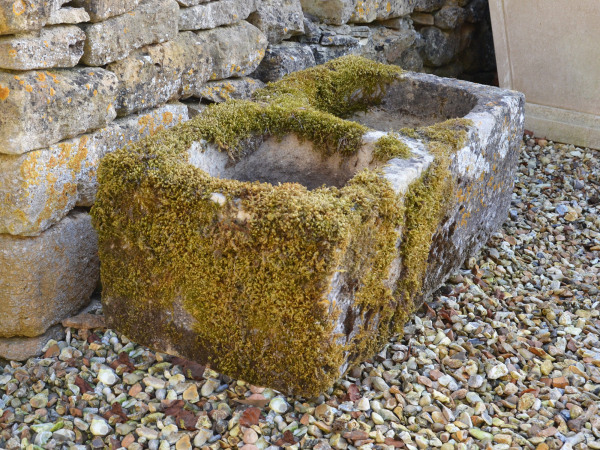An antique limestone trough with good weathering and patination