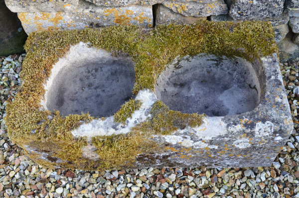 An antique limestone trough with good weathering and patination