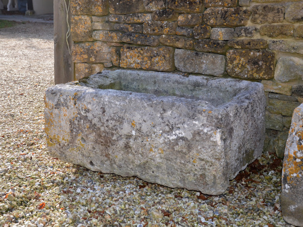 An antique limestone trough with good weathering and patination