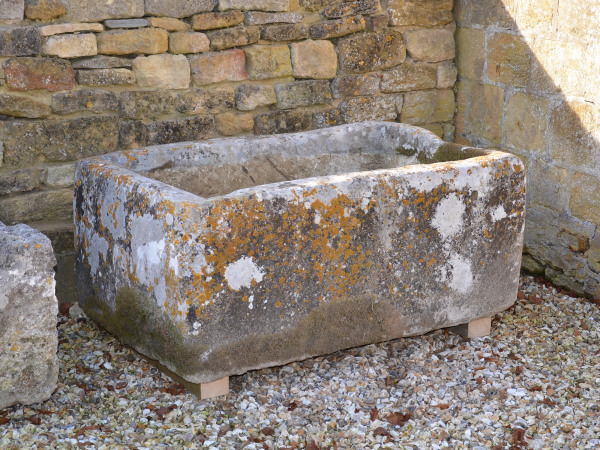 An antique limestone trough with good weathering and patination