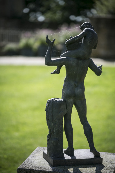 A Neapolitan verdigris bronze model of a young Satyr with the infant Dionysus