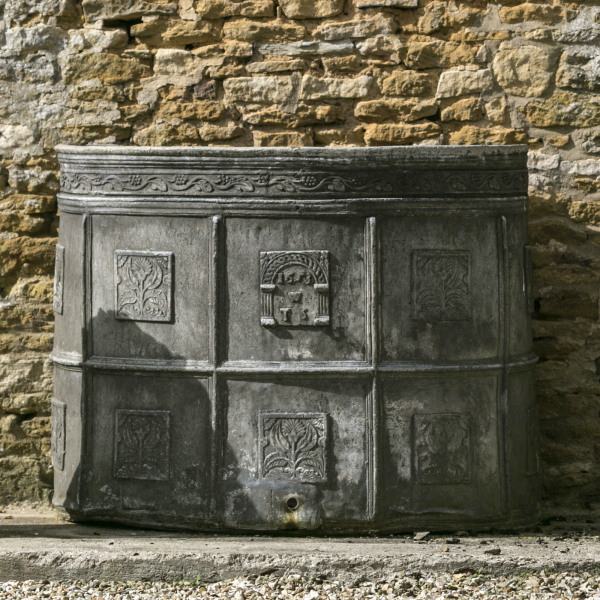 A semi-circular lead cistern Dated 1653