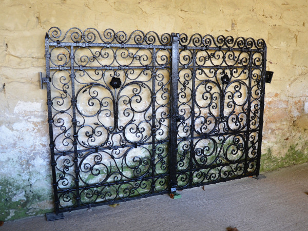 A pair of small early 20th century decorative wrought iron garden gates