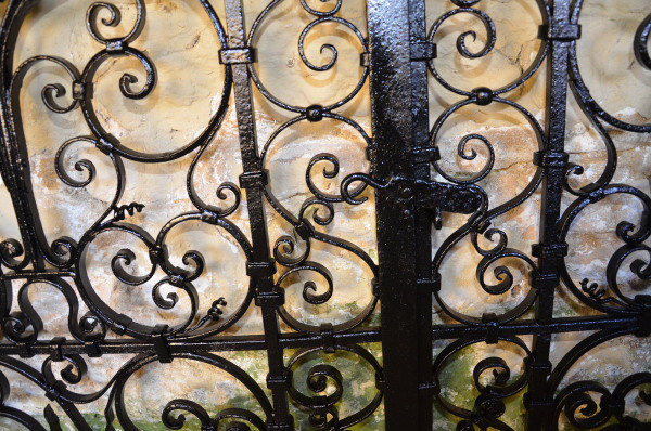 A pair of small early 20th century decorative wrought iron garden gates
