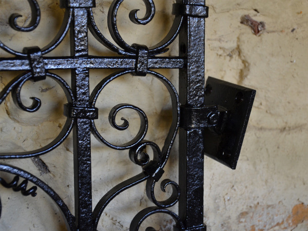 A pair of small early 20th century decorative wrought iron garden gates