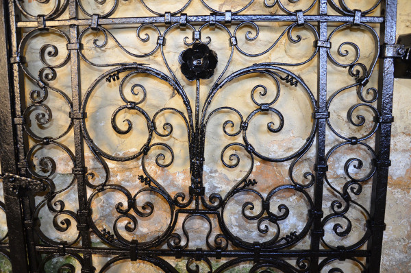 A pair of small early 20th century decorative wrought iron garden gates