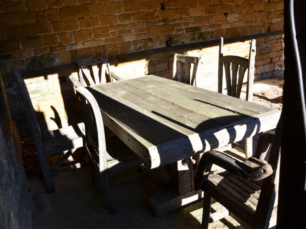 A 20th century rustic hardwood table and six chairs