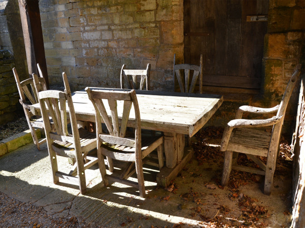 A 20th century rustic hardwood table and six chairs