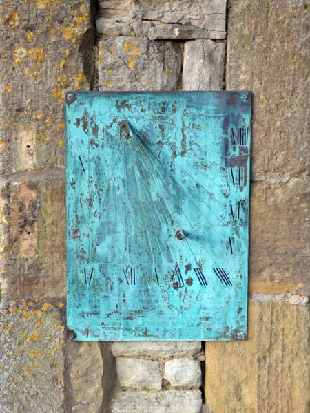 A modern Verdigris wall-mounted brass sundial plate with diagonal indicator
