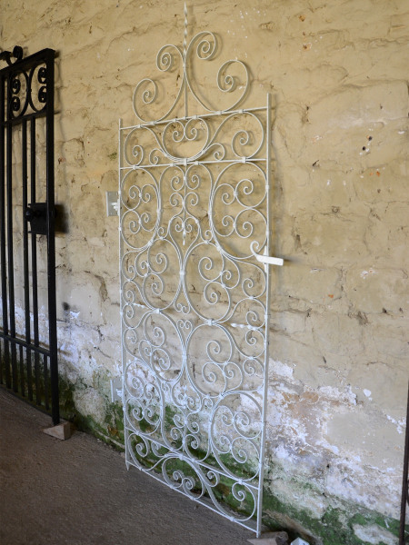 An early 20th century small wrought iron secret garden gate