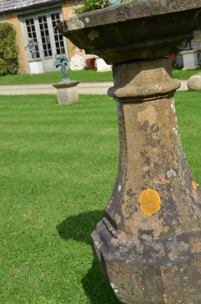 An early 20th century carved natural Horton stone sundial of octagonal form with bronze sundial plate
