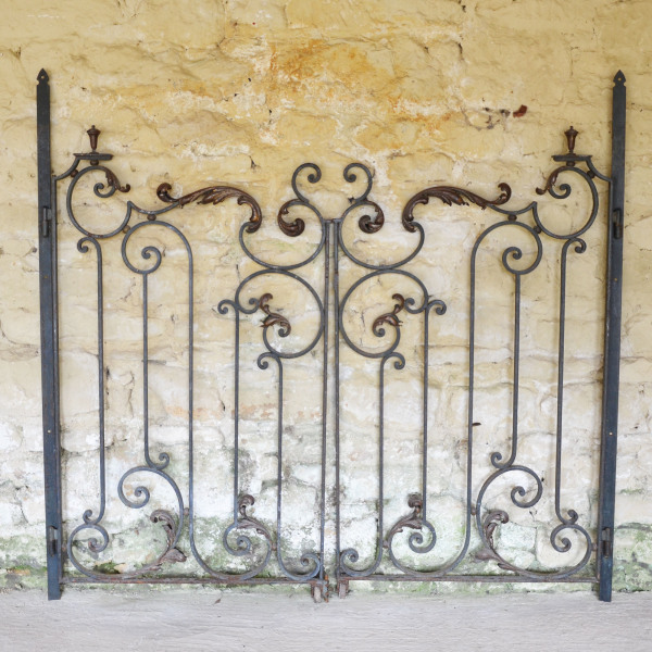 A pair of early 20th century forged iron and brass gates