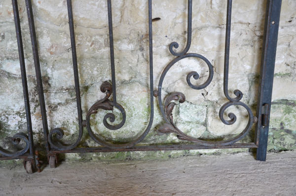 A pair of early 20th century forged iron and brass gates