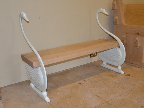 A cast iron swan bench