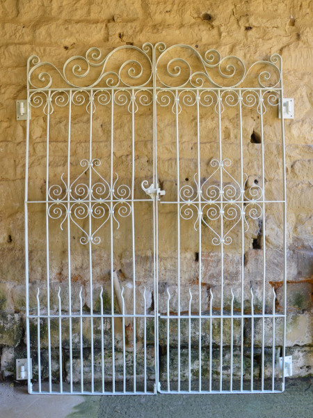 A pair of decorative wrought iron garden gates