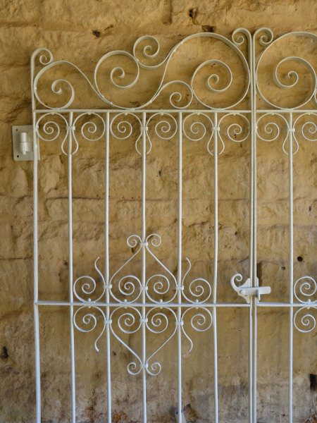 A pair of decorative wrought iron garden gates